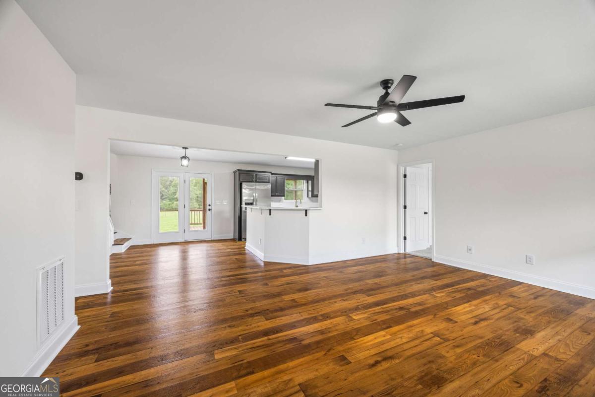 1718 Ed Bennett Road Nicholson, GA 30565 - Photo 19 of 70 a view of empty room with wooden floor and window