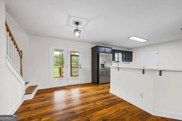 a kitchen with stainless steel appliances granite countertop a refrigerator and a sink