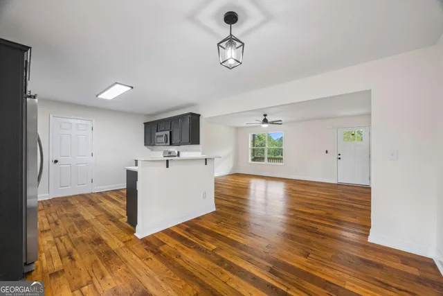 a kitchen with stainless steel appliances granite countertop a sink dishwasher stove and refrigerator