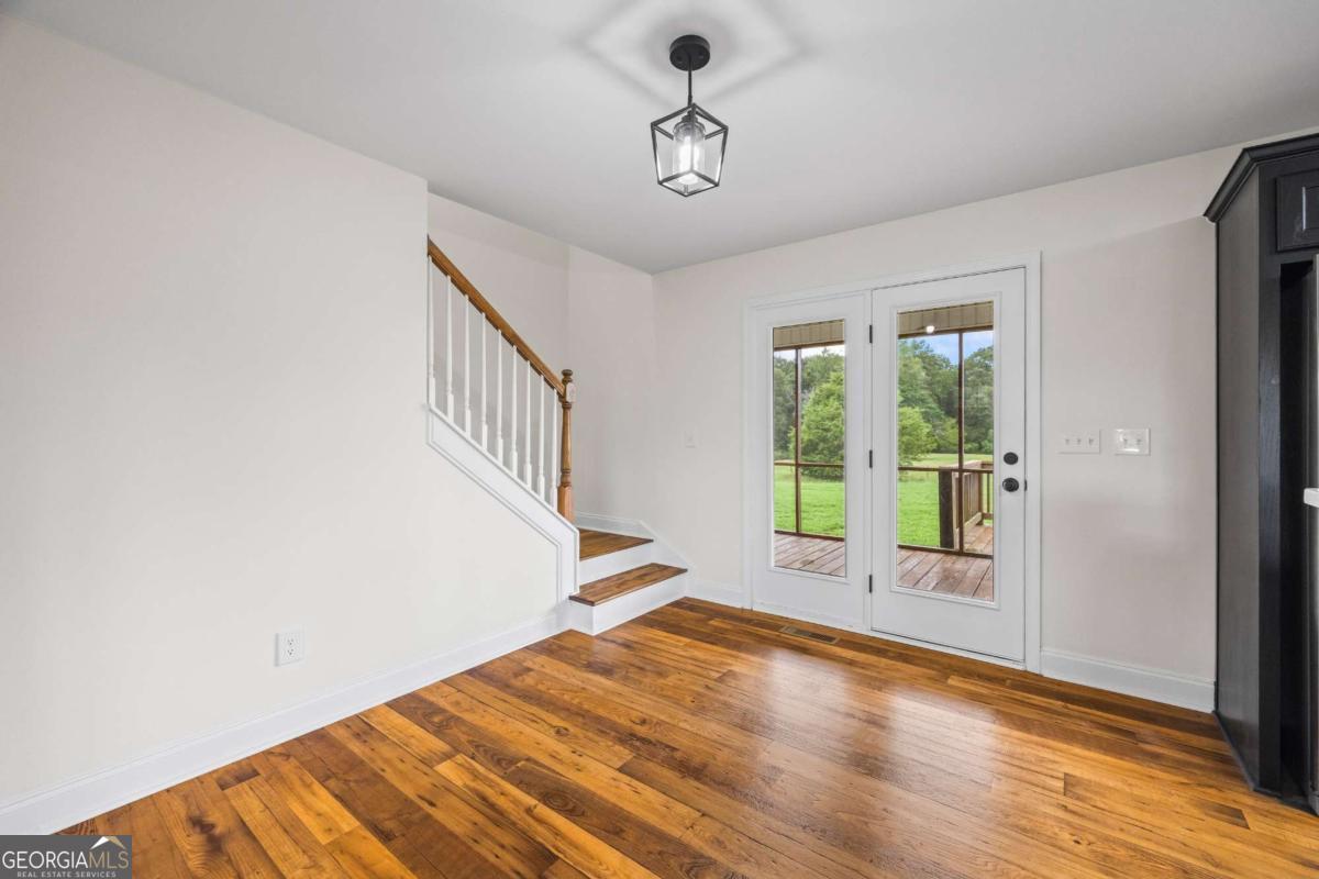 1718 Ed Bennett Road Nicholson, GA 30565 - Photo 27 of 71 a view of an empty room with wooden floor and a window