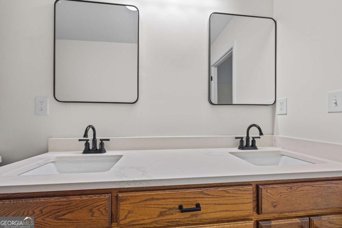 1718 Ed Bennett Road Nicholson, GA 30565 - Photo 38 of 70 a bathroom with a sink and mirror