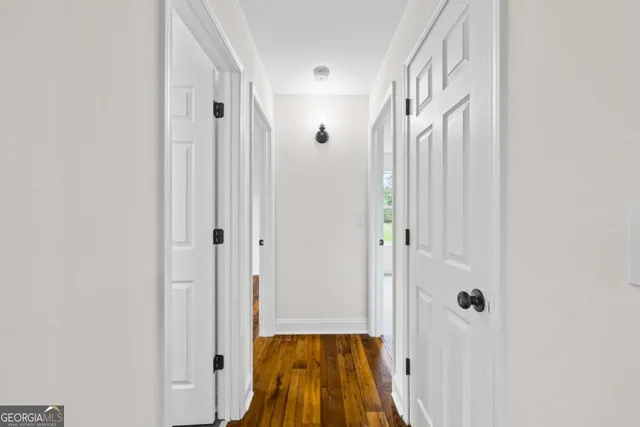 an empty room with windows and mirror