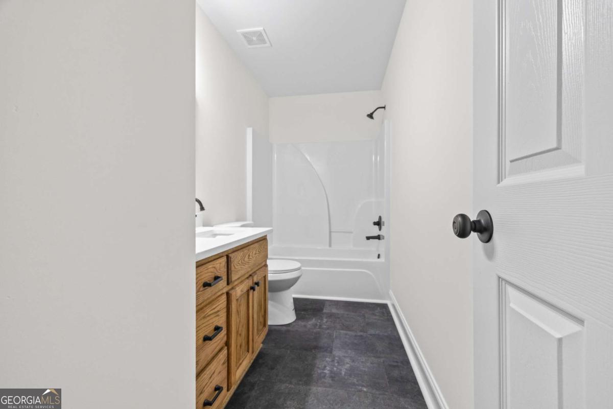 1718 Ed Bennett Road Nicholson, GA 30565 - Photo 47 of 70 a bathroom with a sink a toilet and shower