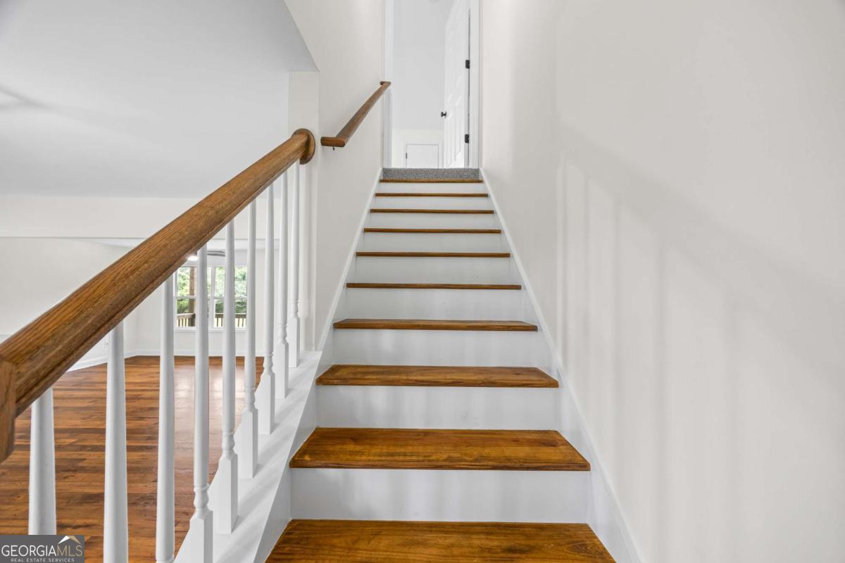 1718 Ed Bennett Road Nicholson, GA 30565 - Photo 49 of 71 a view of staircase with wooden floor and white walls