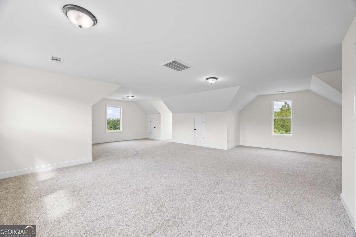 1718 Ed Bennett Road Nicholson, GA 30565 - Photo 51 of 70 an empty room with windows and mirror