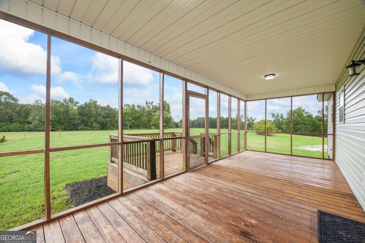 1718 Ed Bennett Road Nicholson, GA 30565 - Photo 61 of 71 a view of deck with a floor to ceiling windows with wooden floor