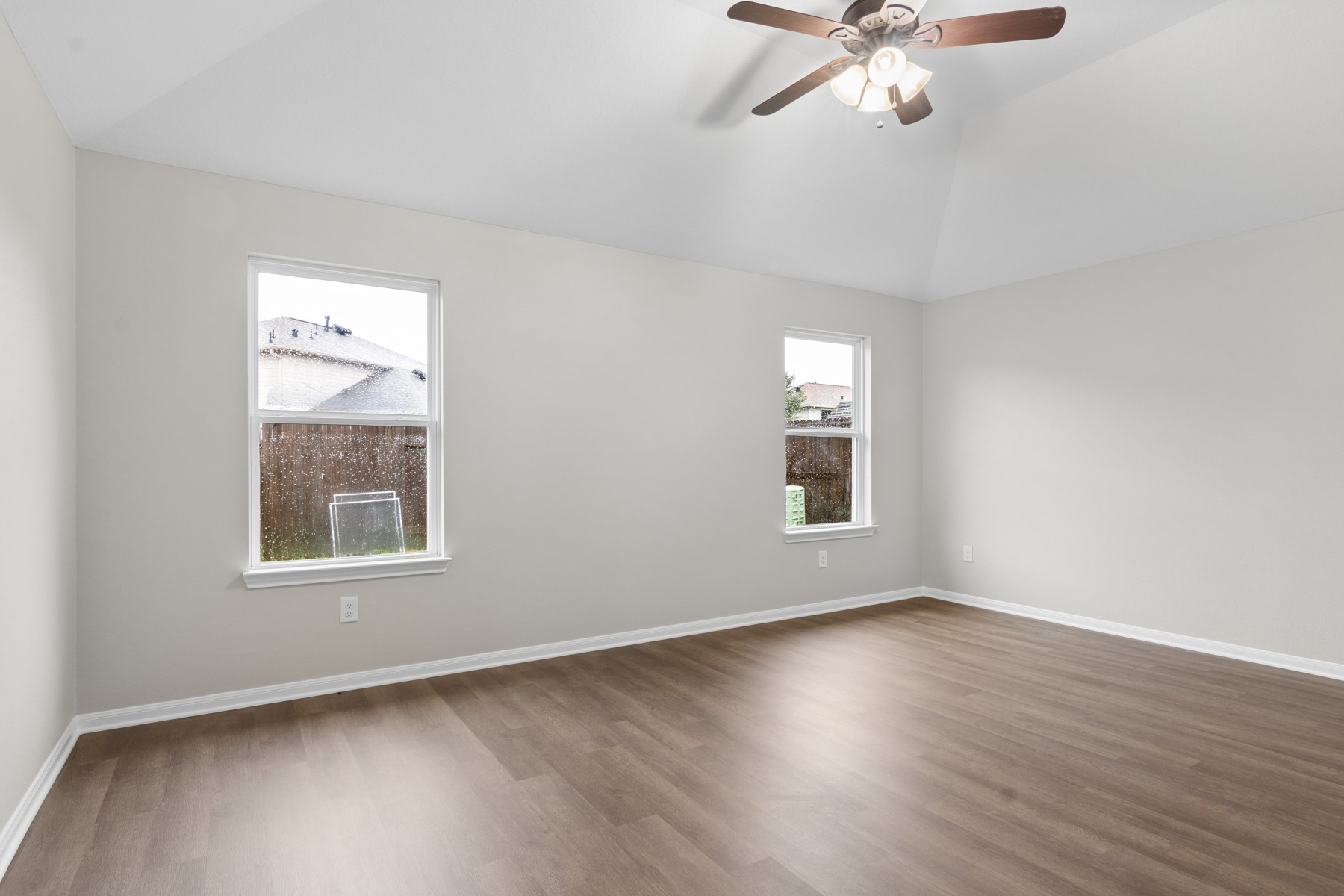 7811 Adonis Avenue Baytown, TX 77521 - Photo 22 of 36 a view of an empty room with wooden floor and a window
