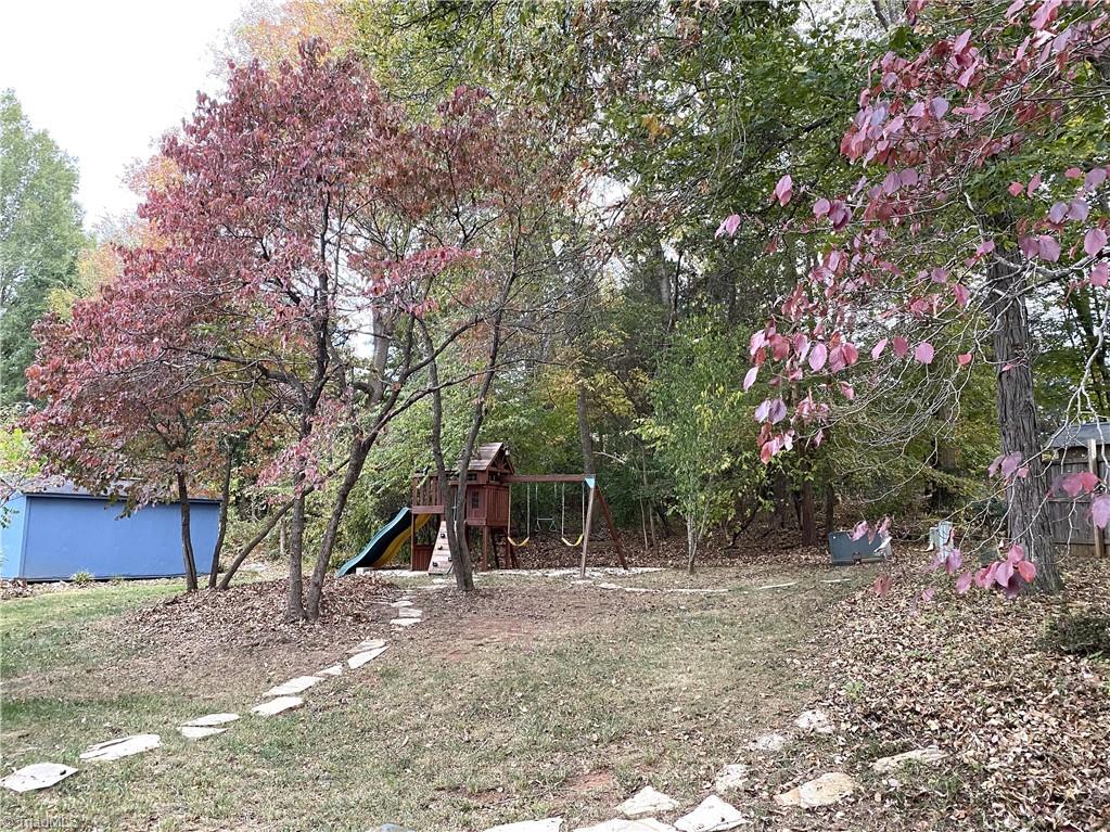 422 Wildwood Lane Graham, NC 27253 - Photo 18 of 22 Lets head out the back doors. The back yard walkway leads you to a great surprise.