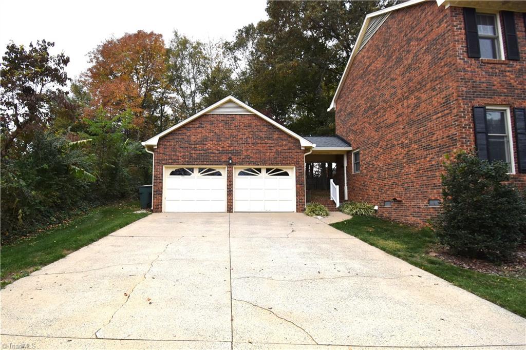 422 Wildwood Lane Graham, NC 27253 - Photo 22 of 22 The parking area and veranda attaching the garage to the house.