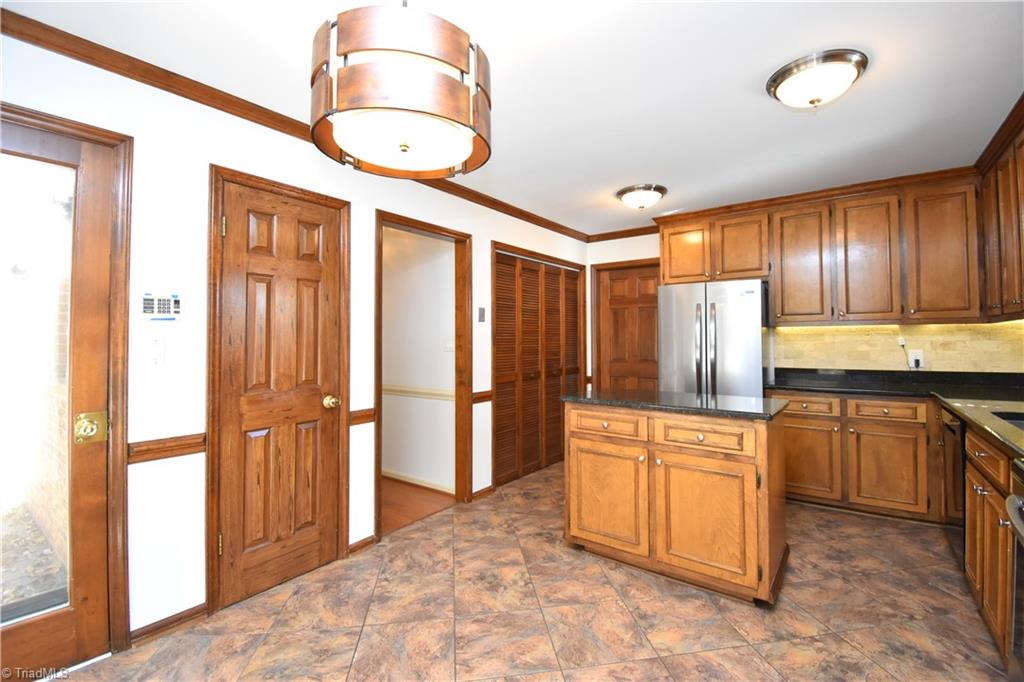 422 Wildwood Lane Graham, NC 27253 - Photo 5 of 22 A view from the eat in back towards the kitchen. On the left the access to the back porch.