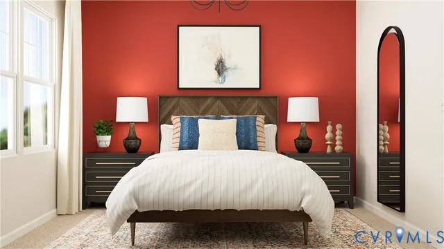 a bed sitting in a bedroom next to a lamp