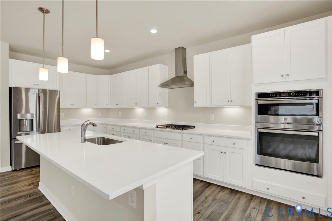 15712 Greenhart Drive Chesterfield, VA 23832 - Photo 8 of 32 a kitchen with stainless steel appliances a stove a sink a oven a refrigerator and cabinets