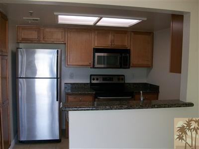 43376 Cook Street, Unit 127 Palm Desert, CA 92211 - Photo 1 of 31 a kitchen with stainless steel appliances granite countertop a refrigerator a stove top oven a sink and dishwasher