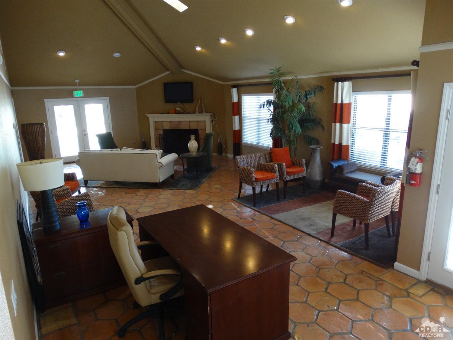 43376 Cook Street, Unit 127 Palm Desert, CA 92211 - Photo 15 of 31 a living room with furniture a fireplace and a flat screen tv