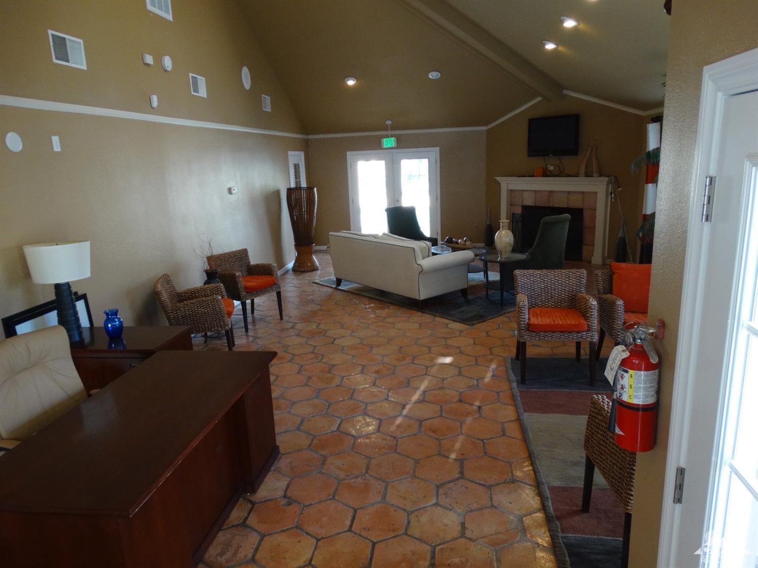 43376 Cook Street, Unit 127 Palm Desert, CA 92211 - Photo 16 of 31 a living room with furniture and a fireplace