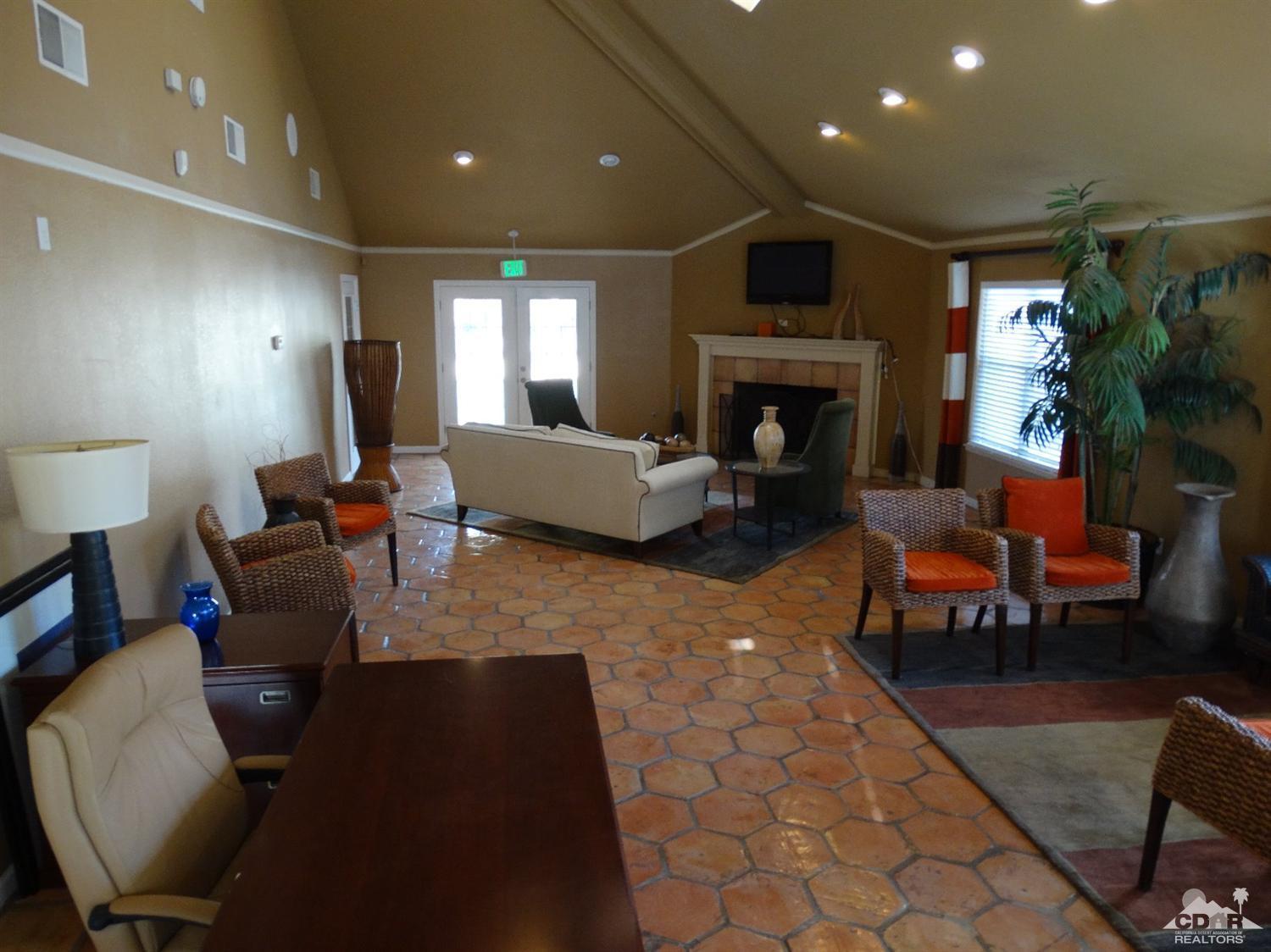 43376 Cook Street, Unit 127 Palm Desert, CA 92211 - Photo 18 of 31 a living room with furniture a fireplace and a potted plant