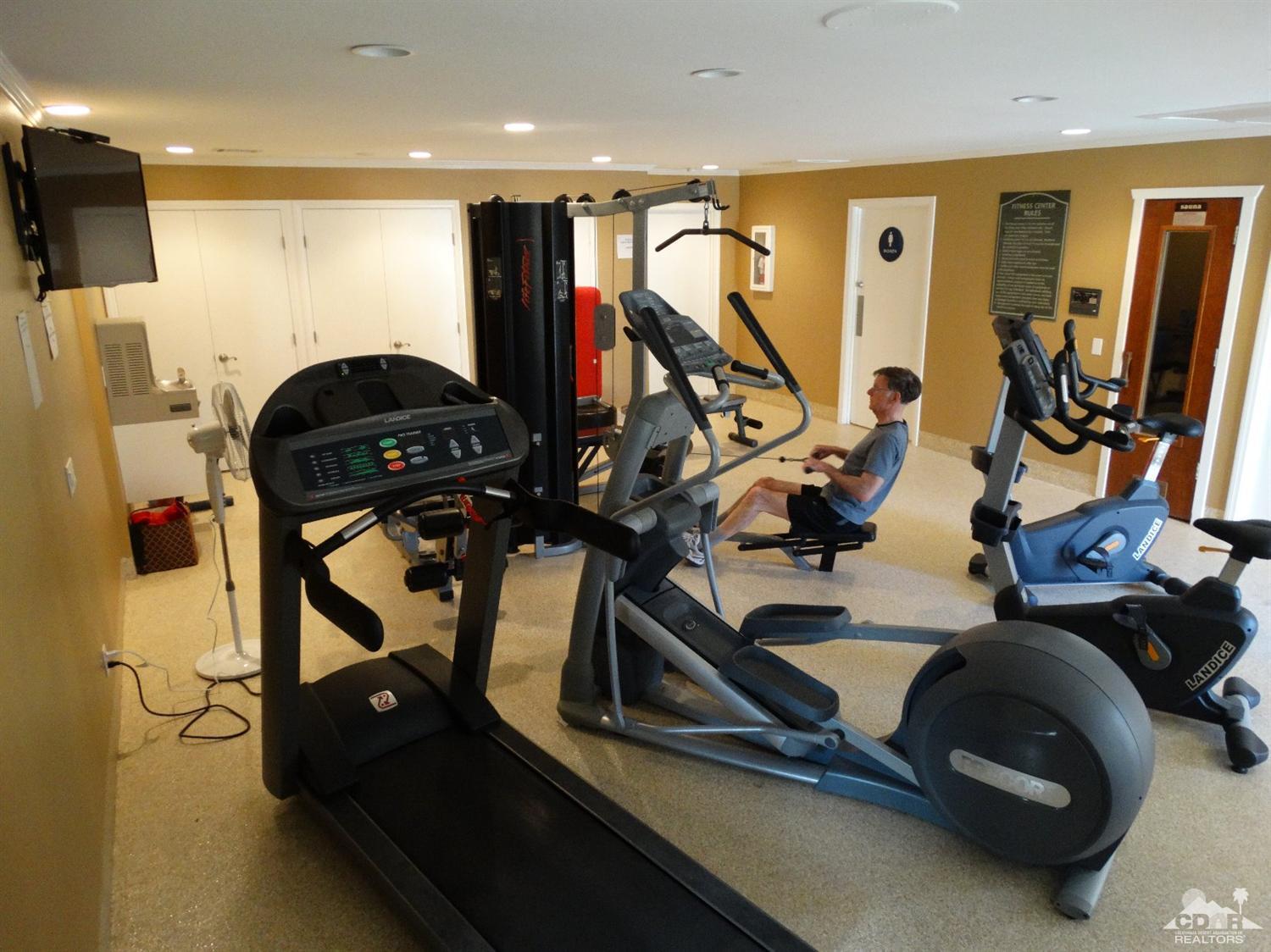 43376 Cook Street, Unit 127 Palm Desert, CA 92211 - Photo 20 of 31 a room with gym equipment and mirror