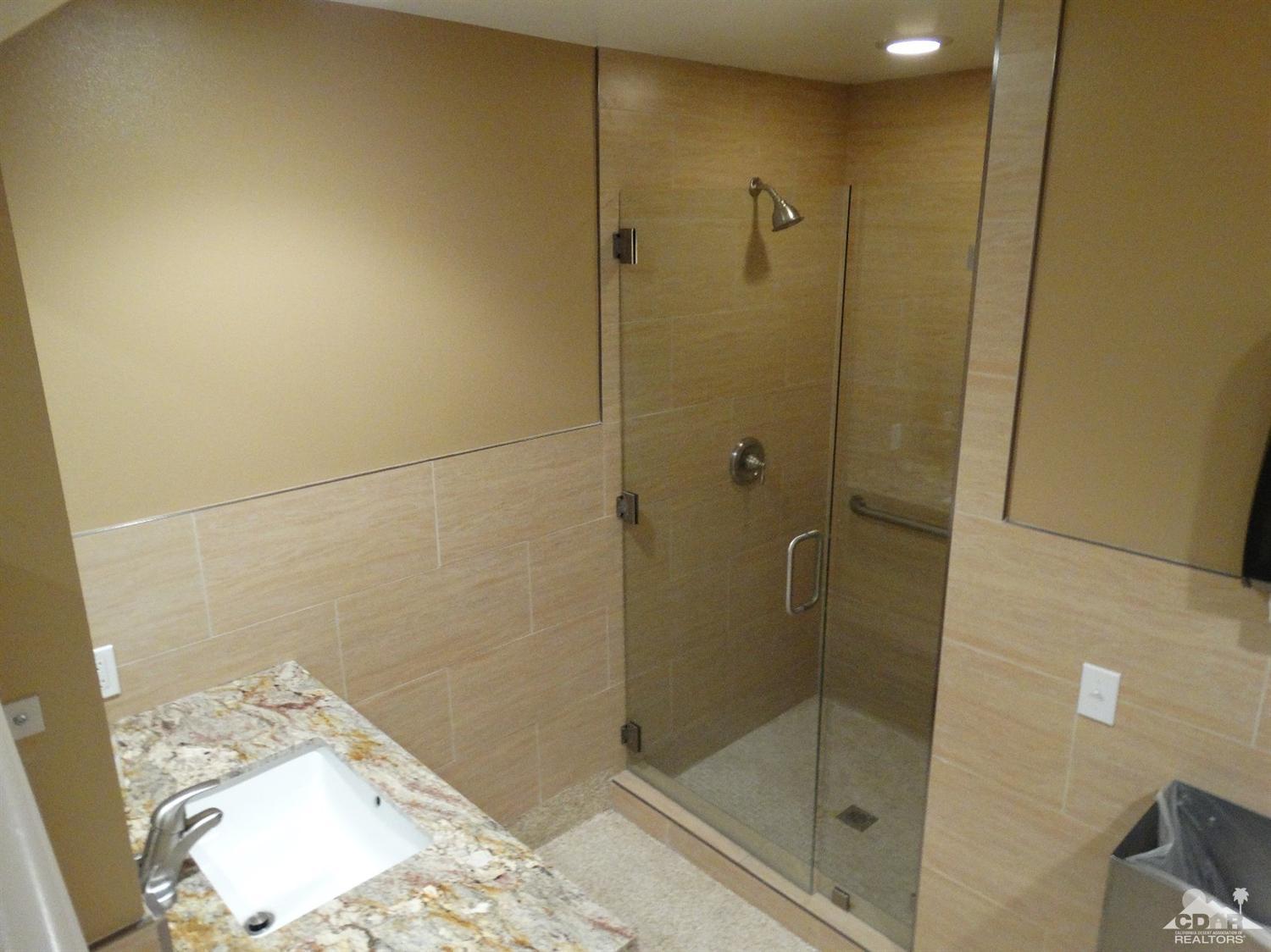 43376 Cook Street, Unit 127 Palm Desert, CA 92211 - Photo 24 of 31 a bathroom with a shower and a sink