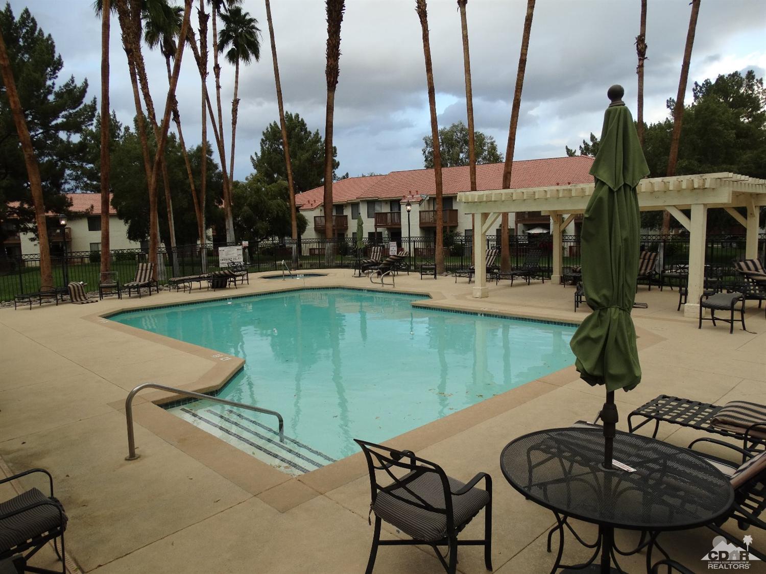 43376 Cook Street, Unit 127 Palm Desert, CA 92211 - Photo 30 of 31 a view of a swimming pool with chairs