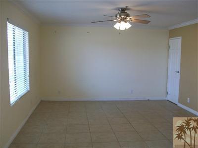 43376 Cook Street, Unit 127 Palm Desert, CA 92211 - Photo 3 of 31 an empty room with windows and fan