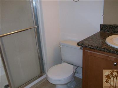 43376 Cook Street, Unit 127 Palm Desert, CA 92211 - Photo 6 of 31 a bathroom with a granite countertop toilet and a sink