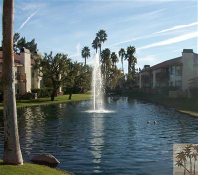 43376 Cook Street, Unit 127 Palm Desert, CA 92211 - Photo 8 of 31 a view of a lake with a yard