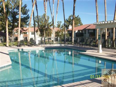 43376 Cook Street, Unit 127 Palm Desert, CA 92211 - Photo 10 of 31 a swimming pool with outdoor seating and yard
