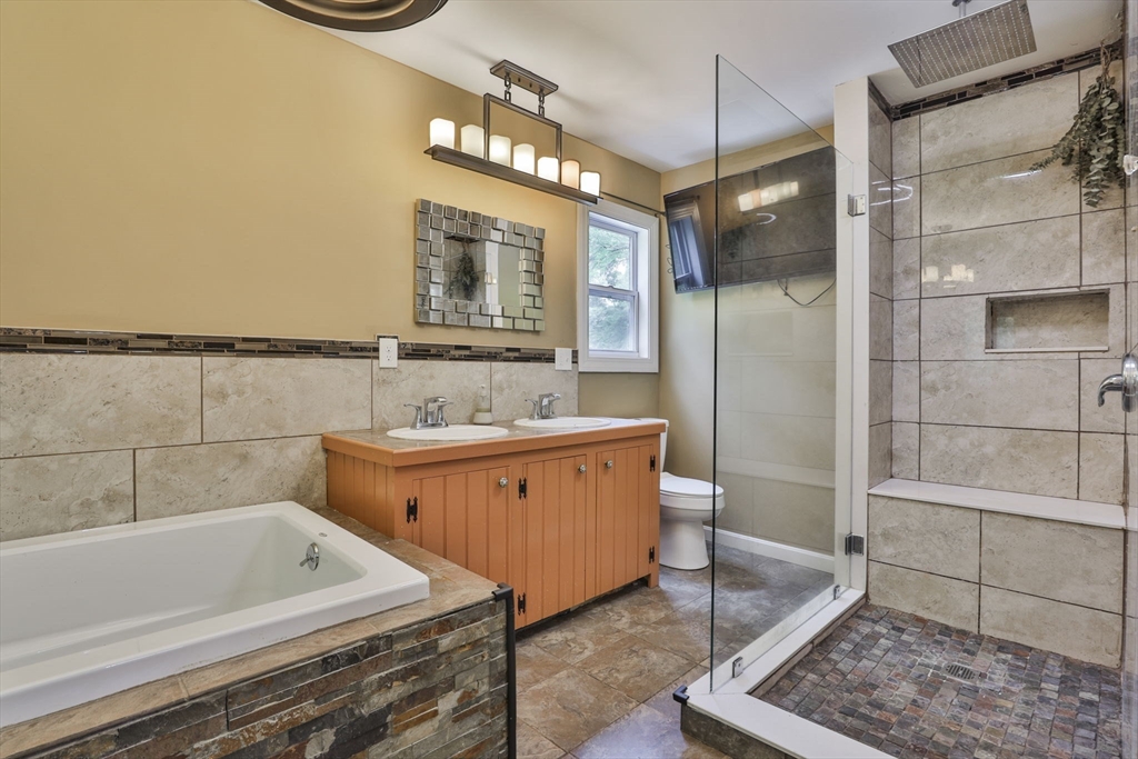 168 East Haynes Road Townsend, MA 01469 - Photo 13 of 23 a bathroom with a bathtub a mirror a shower and vanity
