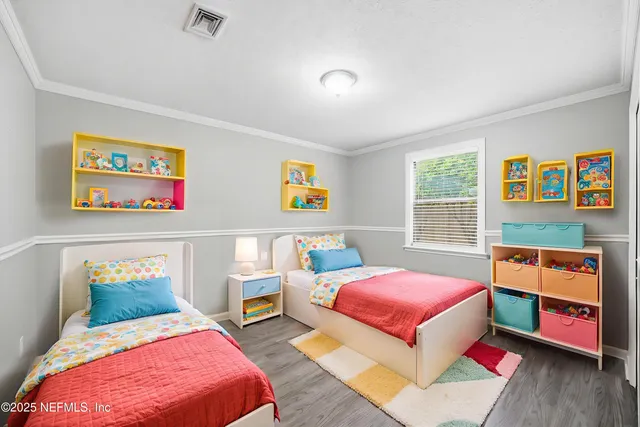 a bedroom with two beds and a couch