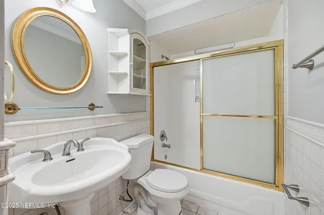 a bathroom with a sink a mirror a toilet and a shower