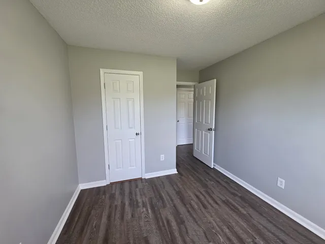 a view of an empty room and wooden floor