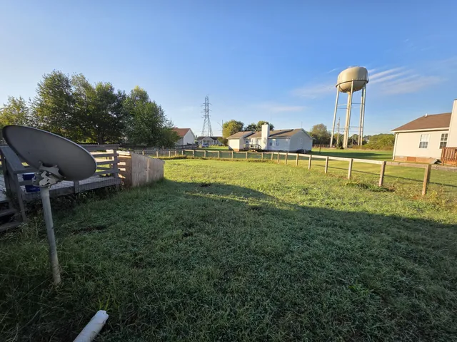 a view of a garden with lawn chairs
