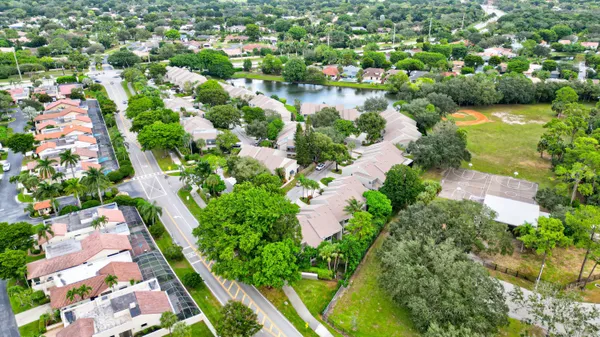 an aerial view of a house with a garden and houses