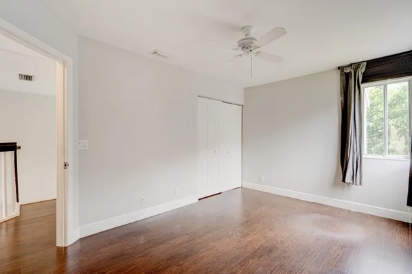 a view of walk in closet with empty racks