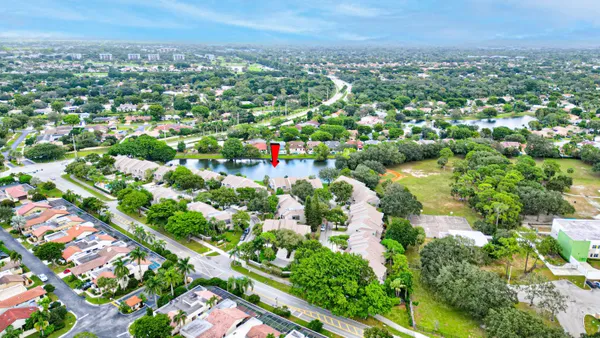 an aerial view of residential houses with outdoor space and trees all around