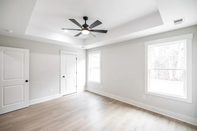 a view of a livingroom with a ceiling fan and window