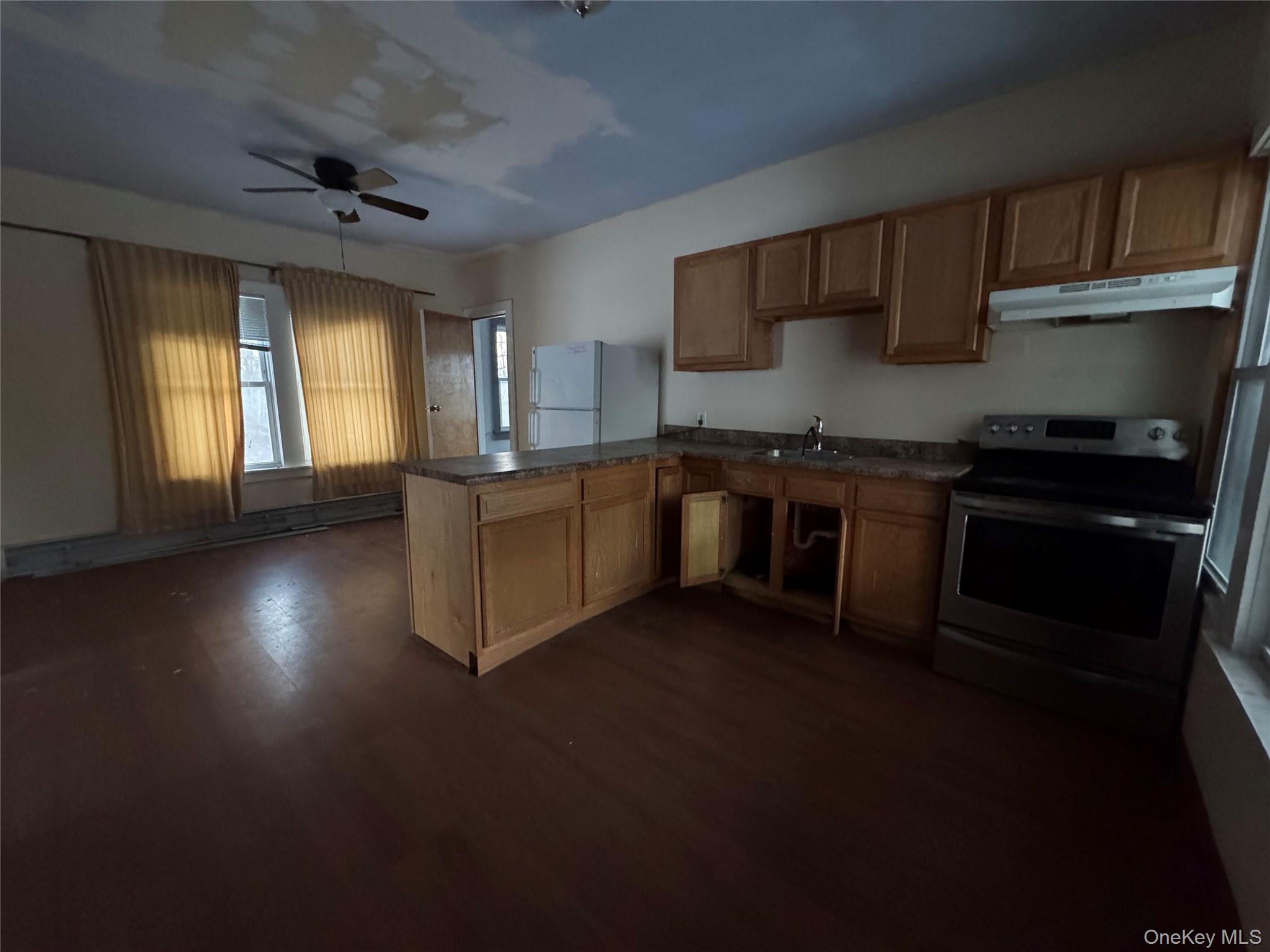 74 Cold Spring Road Liberty, NY 12754 - Photo 5 of 16 a kitchen with stainless steel appliances granite countertop a stove sink and cabinets
