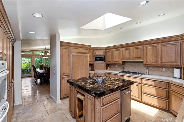 a living room with furniture pool table and a chandelier