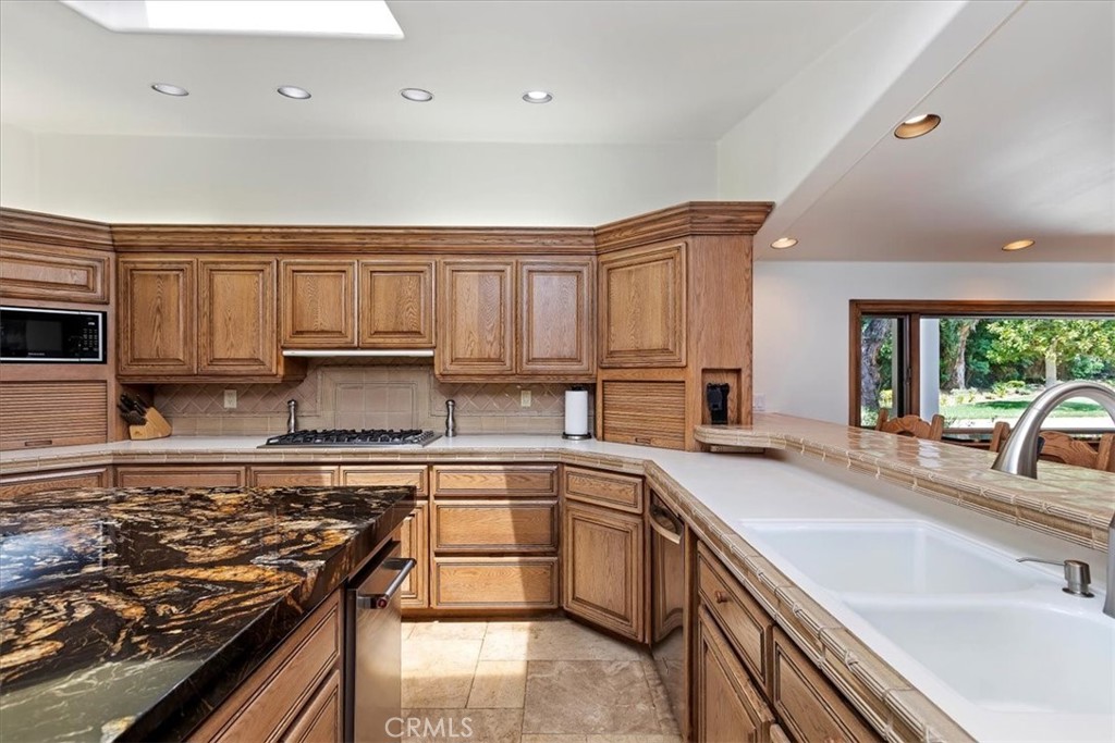 2100 Hathaway Place Riverside, CA 92506 - Photo 14 of 74 a kitchen with a sink stove top oven and cabinets