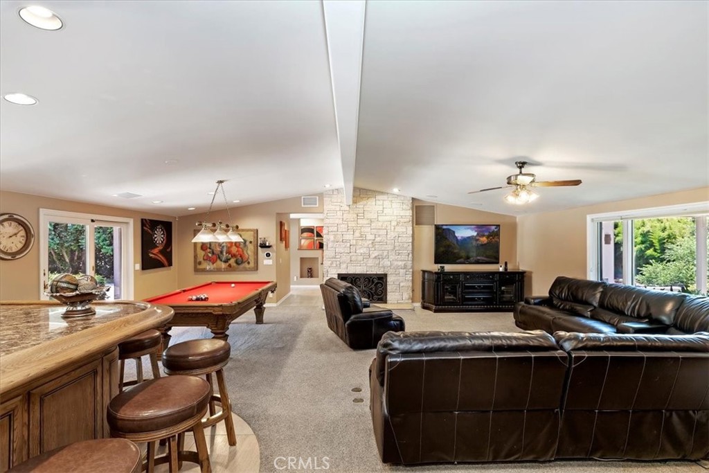 2100 Hathaway Place Riverside, CA 92506 - Photo 19 of 74 a living room with furniture a fireplace and a flat screen tv