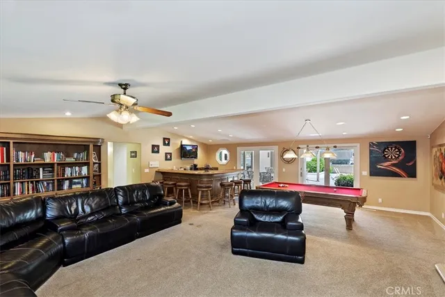 a living room with furniture large window and a fireplace
