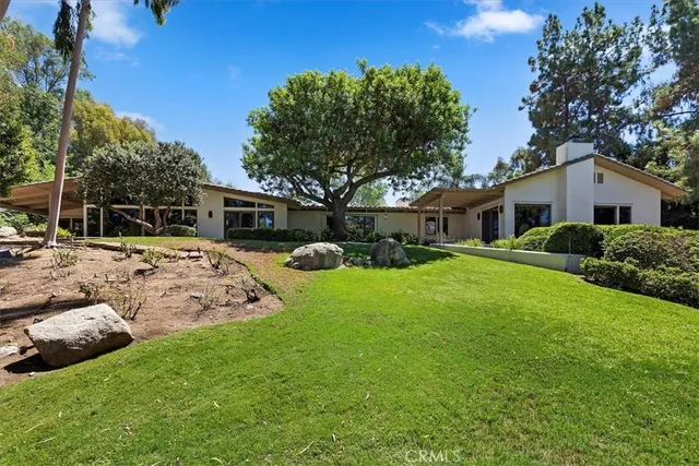 a front view of a house with a yard and a garage