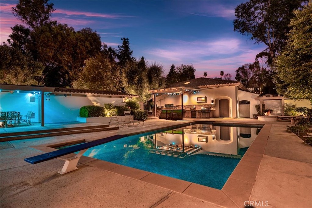 2100 Hathaway Place Riverside, CA 92506 - Photo 58 of 74 a view of a swimming pool with a bench in front of house