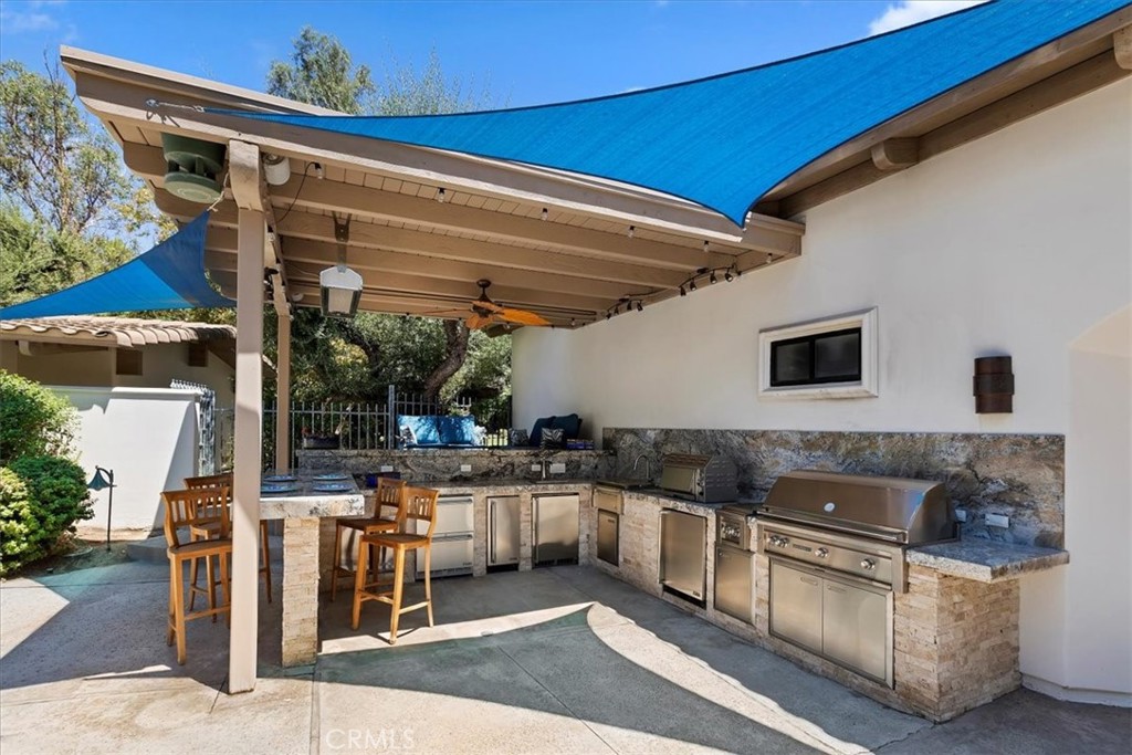 2100 Hathaway Place Riverside, CA 92506 - Photo 64 of 74 a kitchen with stainless steel appliances granite countertop a stove and a sink
