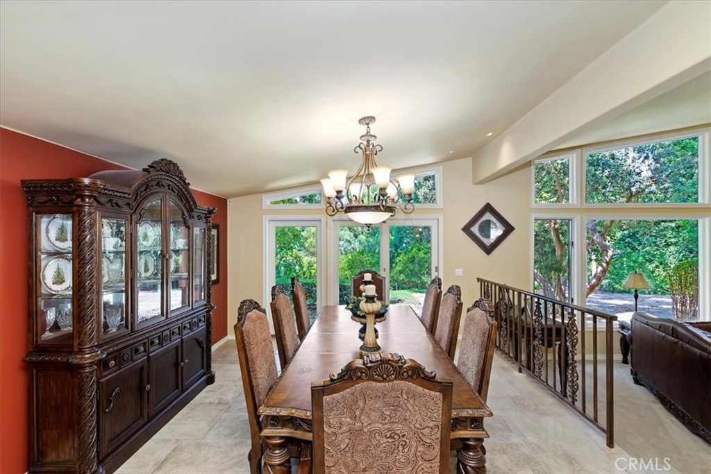 2100 Hathaway Place Riverside, CA 92506 - Photo 10 of 74 a view of a dining room with furniture a chandelier and large windows