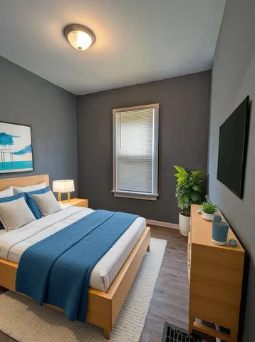 a bedroom with a large bed and a flat screen tv