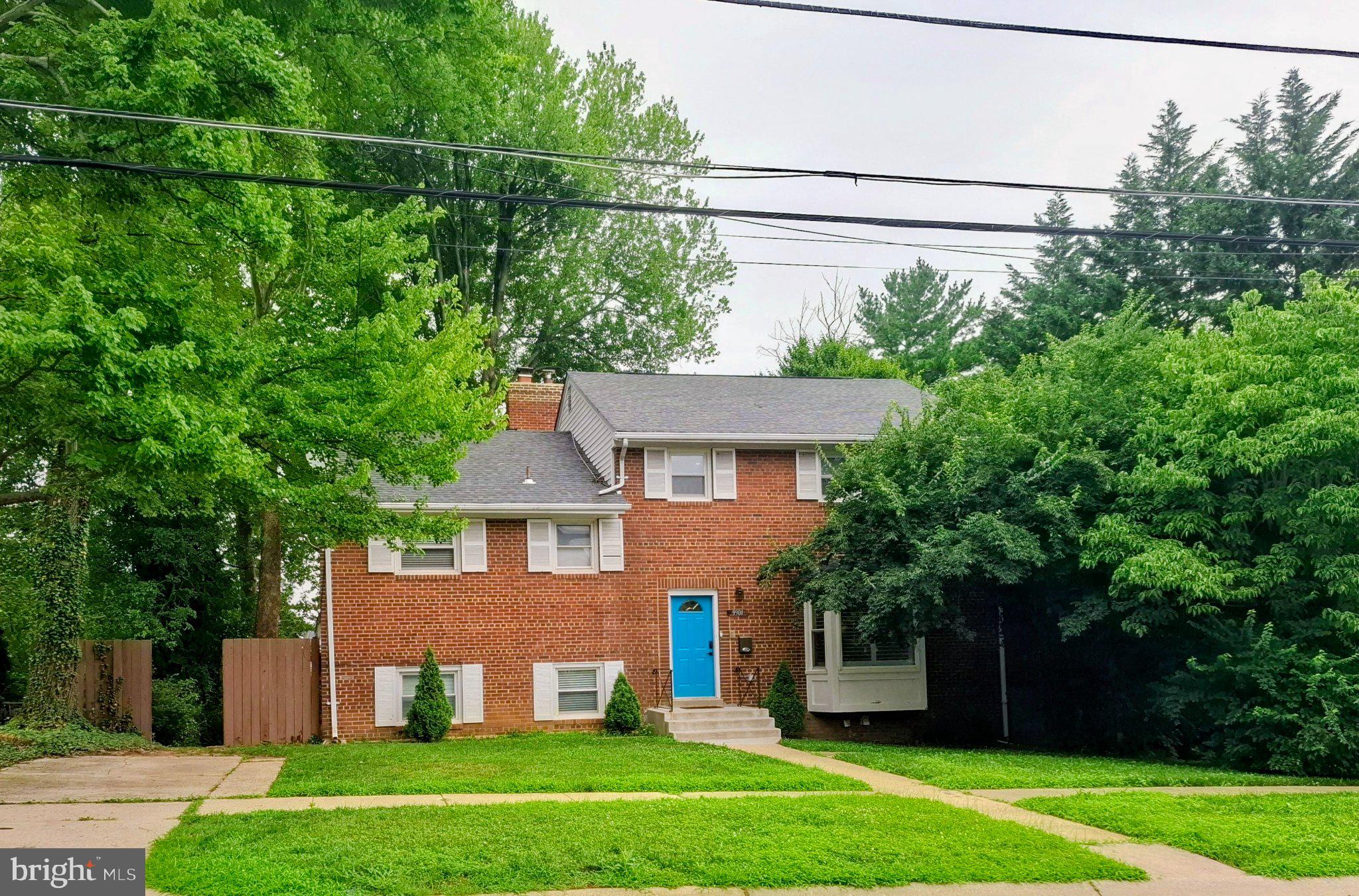 9901 Belhaven Road Bethesda, MD 20817 - Photo 1 of 1 Charming brick home with vibrant blue door.