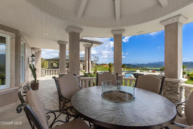 a dining hall with stainless steel appliances a dining table and chairs with wooden floor