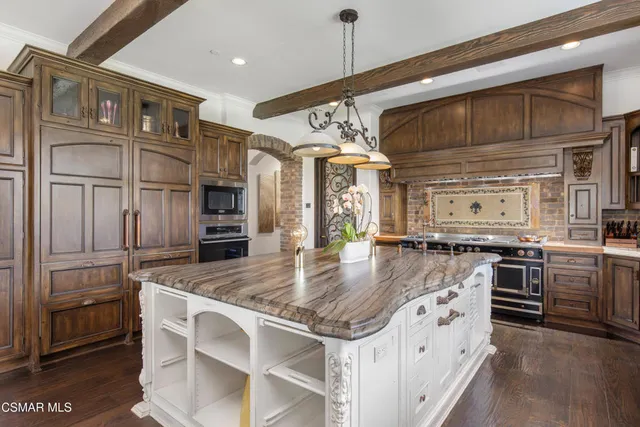 a large bedroom with a bed and a fireplace