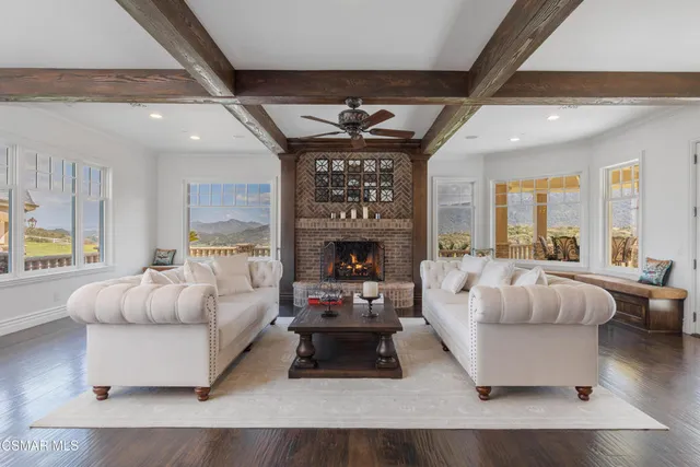 a view of a house with a yard and sitting area